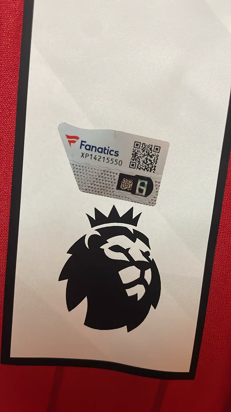 Numbered Fanatics hologram next to the Premier League patch on an Arsenal shirt