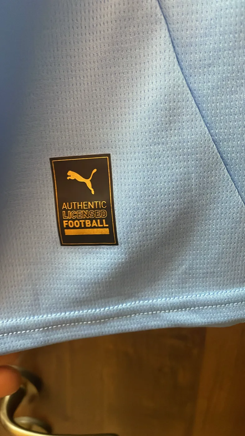 Inner authenticity label with official Puma licence on a football shirt